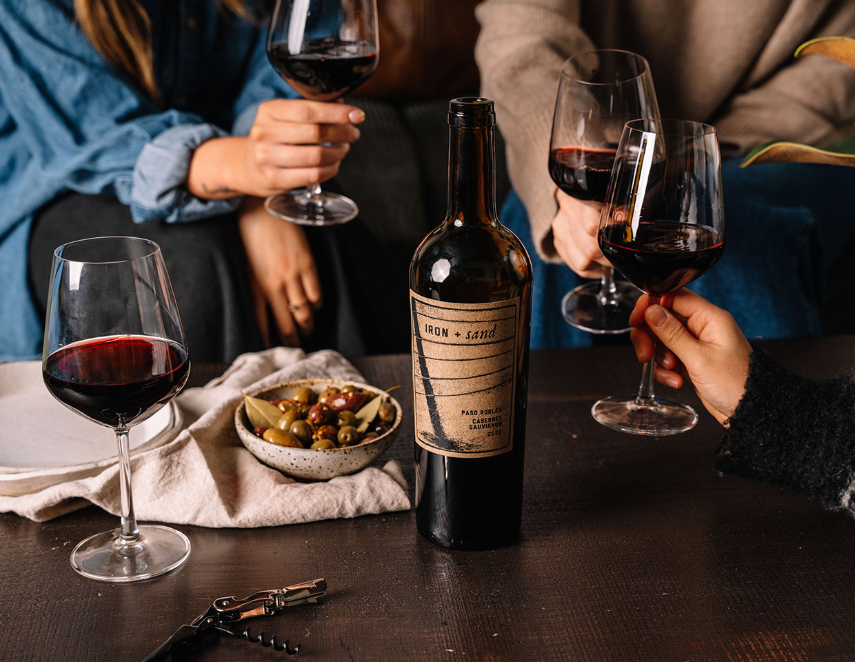 people enjoying glasses of Iron + Sand cabernet sauvignon