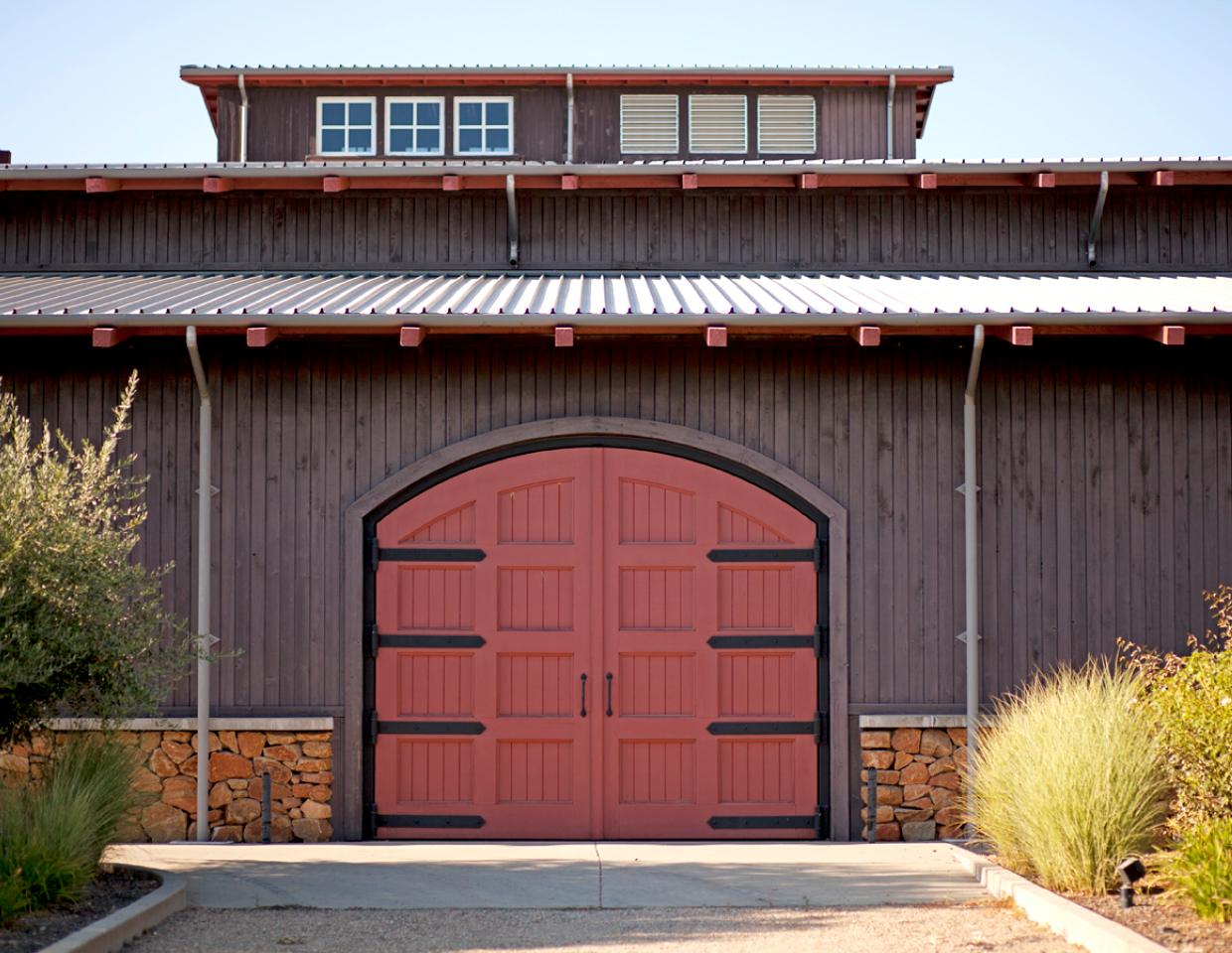 Terra d'Oro winery brown building with red doors.