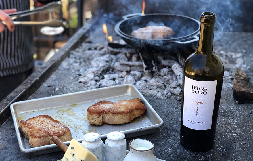 Bottle of Terra d'Oro Zinfandel next to outdoor grill