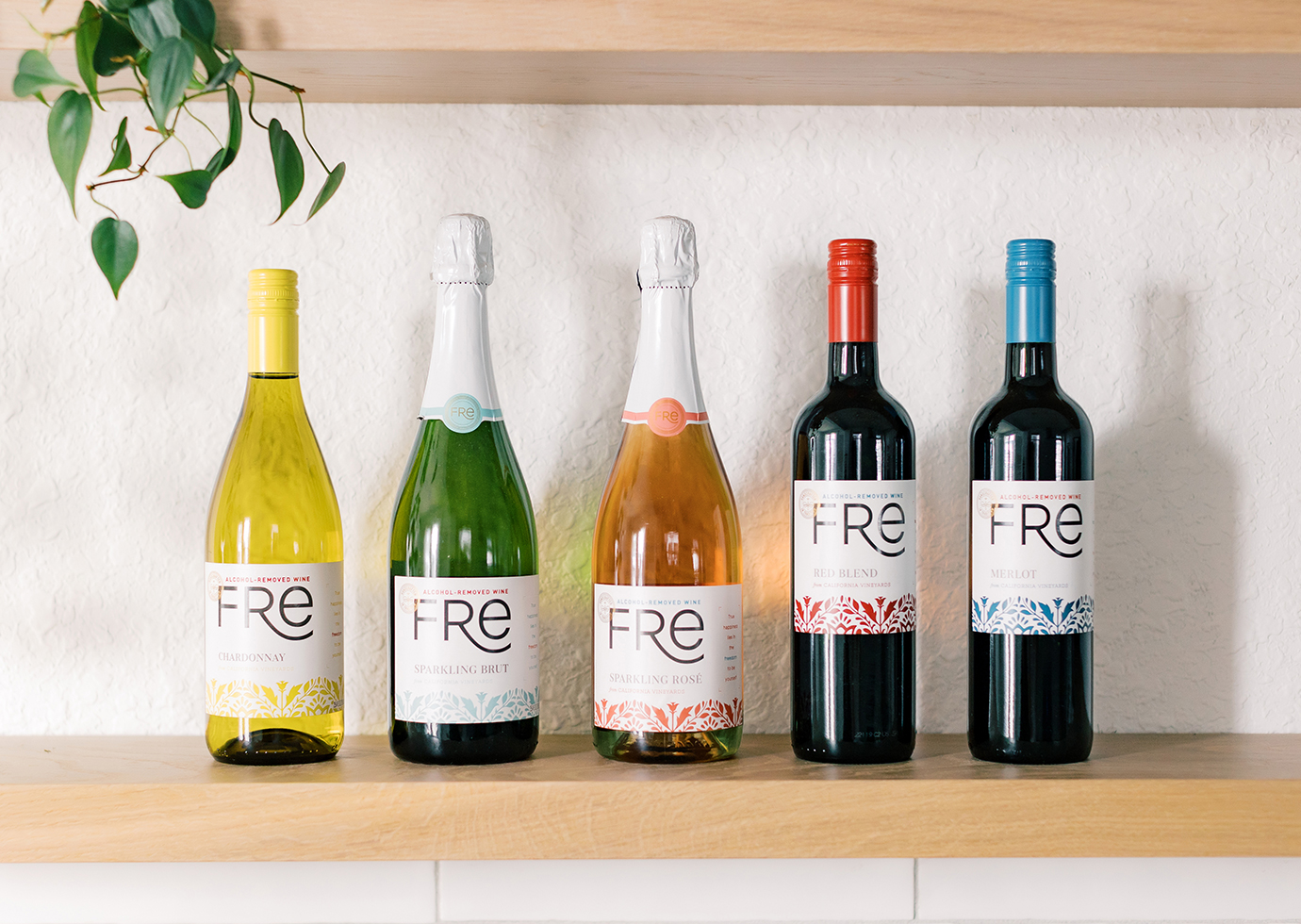 Bottles of FRE wines lined up on a bright kitchen countertop