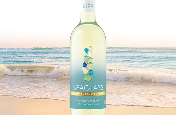 bottle of SEAGLASS alcohol-removed sauvignon blanc with a beautiful blue ocean in the background