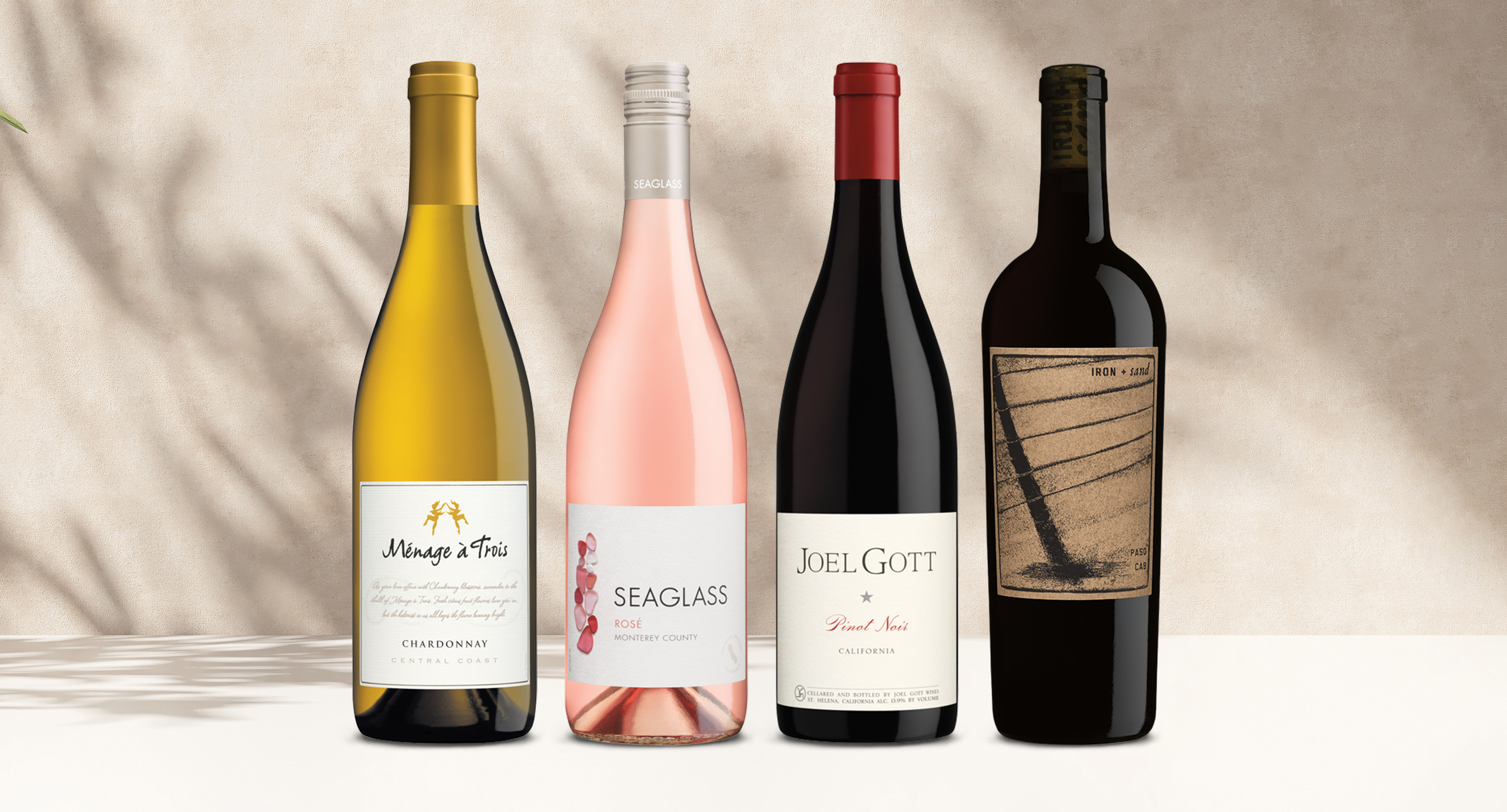 one bottle of menage a trois chardonnay, one bottle of seaglass rose, one bottle of joel gott pinot noir, and one bottle of iron + sand cabernet sauvginon