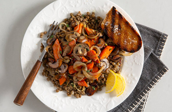 http://a%20white%20bowl%20of%20mushroom%20carrot%20lentils%20with%20lemon%20wedges%20and%20a%20piece%20of%20toast