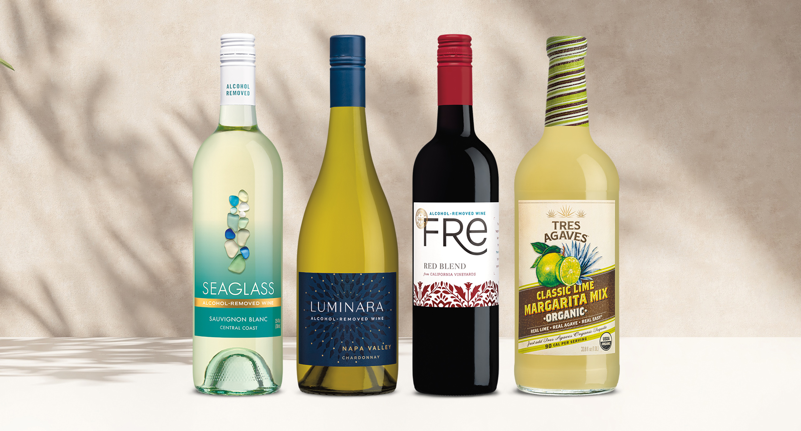 One Stop Wine Shop's Alcohol-Removed Wine Club September shipment featuring SEAGLASS sauvignon blanc, Luminara chardonnay, FRE red blend, and Tres Agaves classic lime margarita mix. Sign up for our wine club!