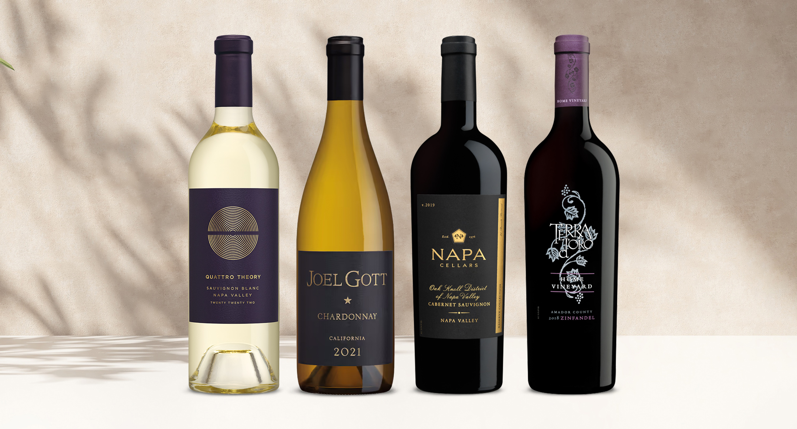 One Stop Wine Shop's Quintessential Wine Club February shipment featuring Quattro Theory, Joel Gott barrel-aged chardonnay, Napa Cellars Reserve Collection cabernet sauvignon, and Terra d'Oro home vineyard zinfandel. Sign up for our wine club!